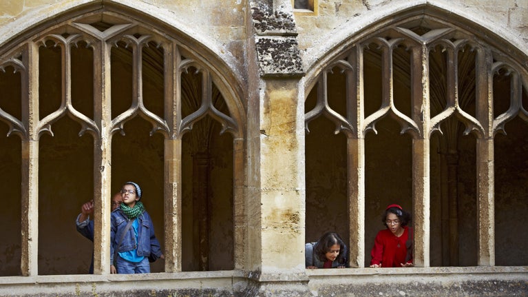 Family visitors in the Cloisters at Lacock Abbey, Wiltshire